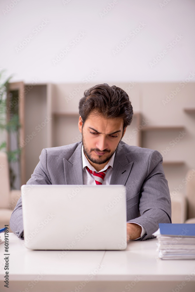 Young male employee working from home during pandemic Young male employee working from home during pandemic