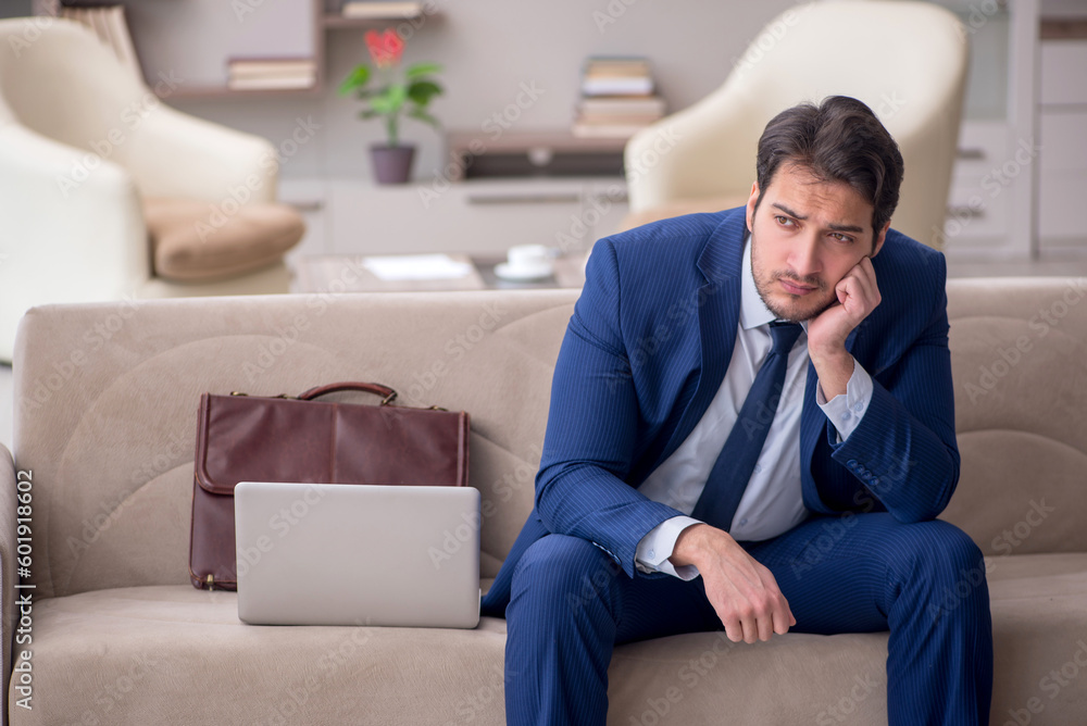 Young male employee working from home during pandemic Young male employee working from home during pandemic