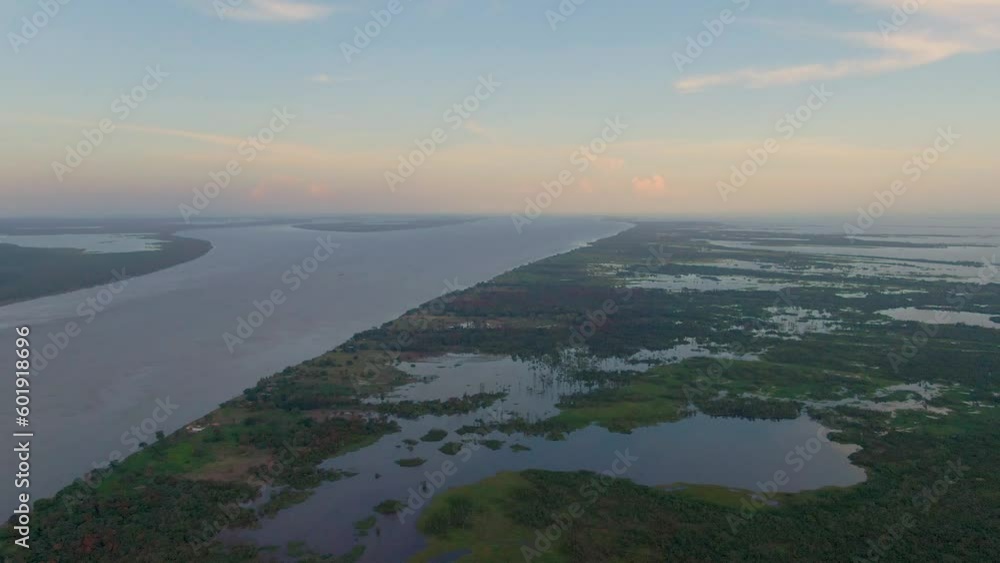 Drone shot over wetlands at the Amazon river, colorful sunset in Obidos, Brazil Drone shot over wetlands at the Amazon river, colorful sunset in Obidos, Brazil