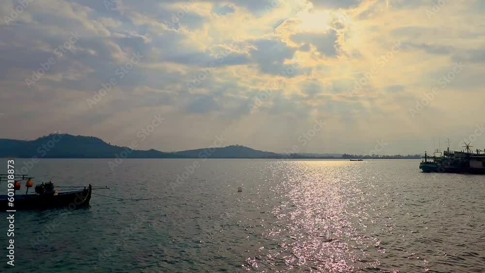 Timelapse of the dreamy and mystical cloudscape and water current in the busy fishing port of Koh Sdach island in Cambodia, candid genuine local lifestyle Timelapse of the dreamy and mystical cloudscape and water current in the busy fishing port of Koh Sdach island in Cambodia, candid genuine local lifestyle