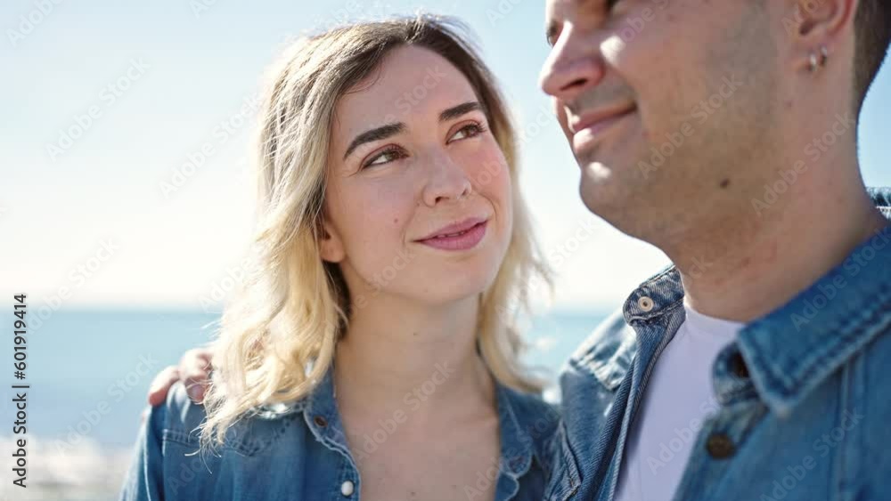 Man and woman couple smiling confident hugging each other at seaside Man and woman couple smiling confident hugging each other at seaside