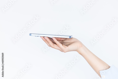 Woman hand holding an empty smartphone isolated on white background, Female waitress hand using smart phone, Concept of digital service .