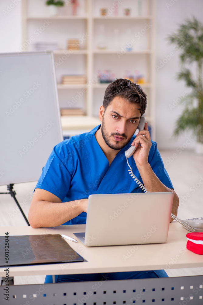 Young male doctor in telemedicine concept Young male doctor in telemedicine concept