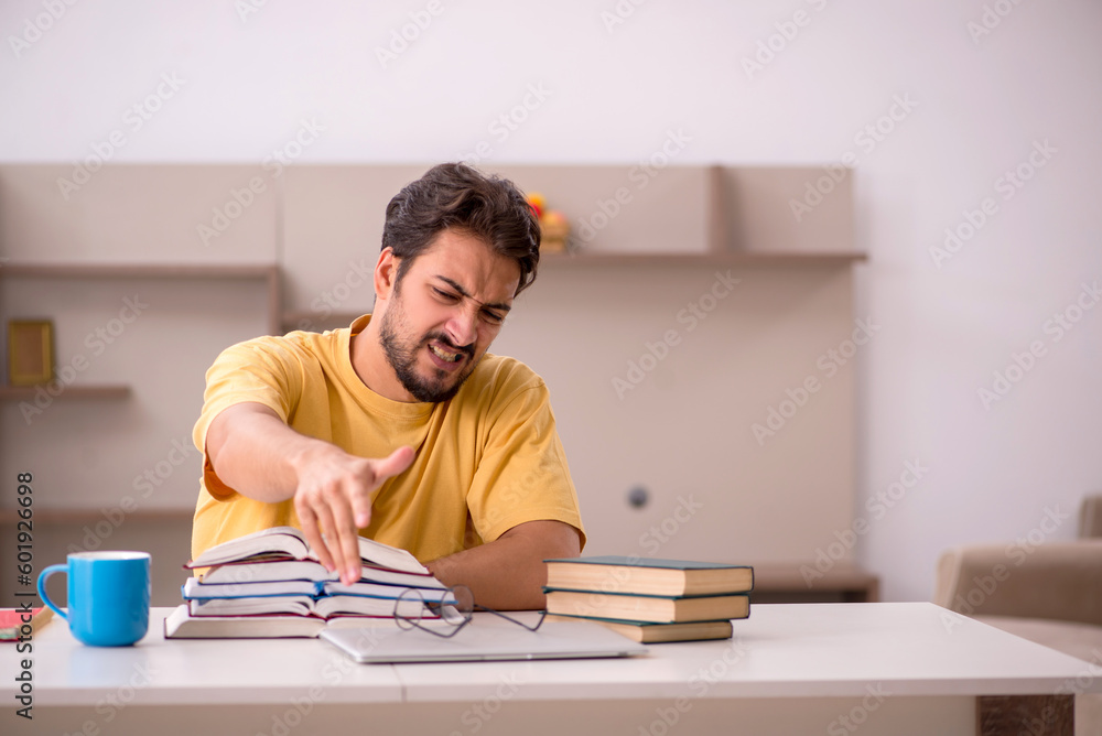 Young male student preparing for exams at home Young male student preparing for exams at home
