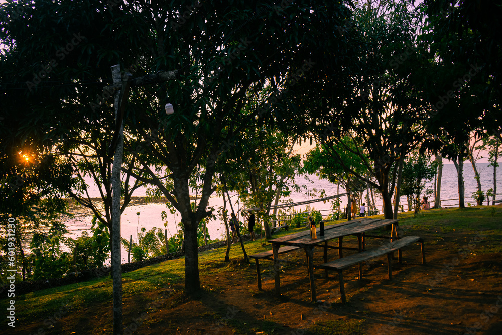 Empty bench by the sea at sunset Empty bench by the sea at sunset