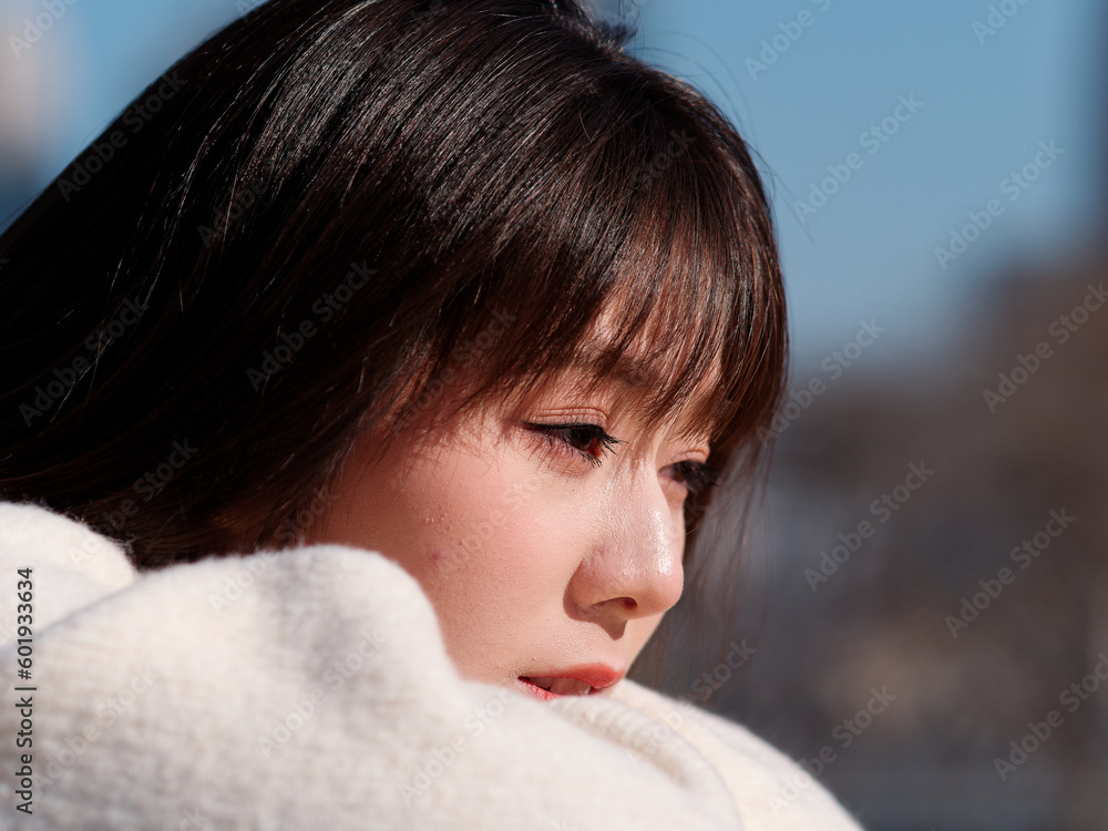 Beautiful young woman with black long hair in white thinking and looking away in sunny day, close up headshot, emotions, people, beauty, travel and lifestyle concept. Beautiful young woman with black long hair in white thinking and looking away in sunny day, close up headshot, emotions, people, beauty, travel and lifestyle concept.