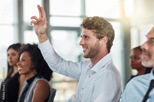Smile, business man and hands raised for questions at conference, seminar or meeting. Male person, happy and hand up for question, asking or answer, vote and training at workshop presentation event.