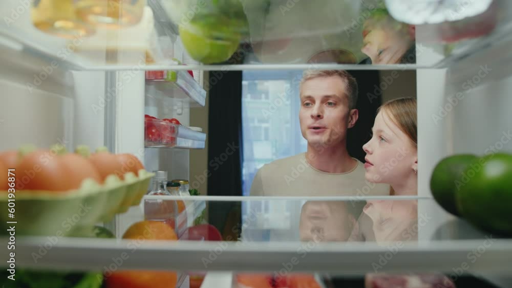 Man and Girl Opening Fridge Door with Healthy Food and Taking Products. Happy Family Cooking Meal and Choosing Ingredients of Refrigerator. Life of Two Smiling People Selecting Storing Grocery to Eat Man and Girl Opening Fridge Door with Healthy Food and Taking Products. Happy Family Cooking Meal and Choosing Ingredients of Refrigerator. Life of Two Smiling People Selecting Storing Grocery to Eat
