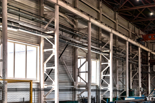 Interior of a modern factory. A bright large workshop. Plant for the production of metal structures. © Anoo