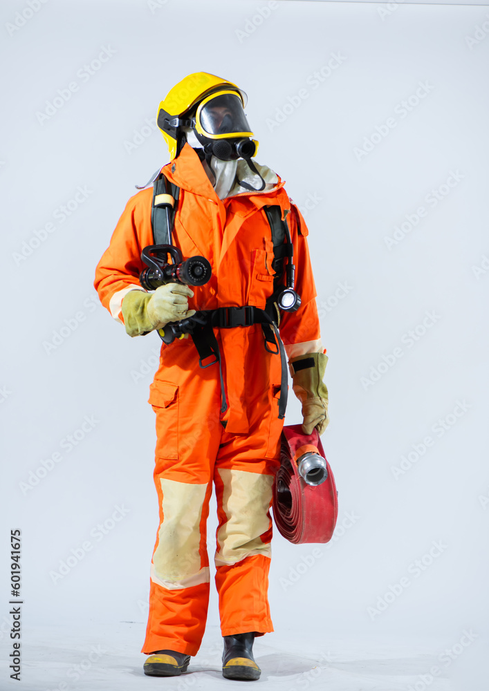 Vertical picture of with a firm grip on the fire hose the firefighter