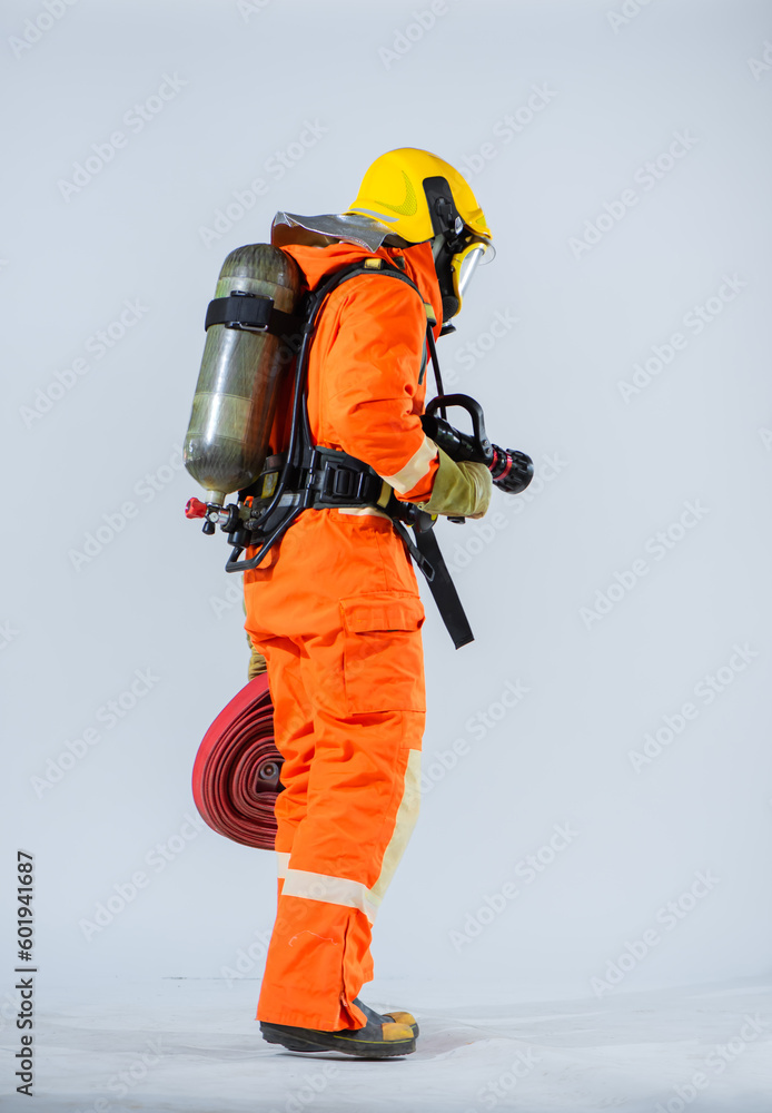 Vertical picture of the firefighter stood tall and confident his back turned to the camera showcasing the resilience and preparedness of those who bravely battle fires. Vertical picture of the firefighter stood tall and confident his back turned to the camera showcasing the resilience and preparedness of those who bravely battle fires.