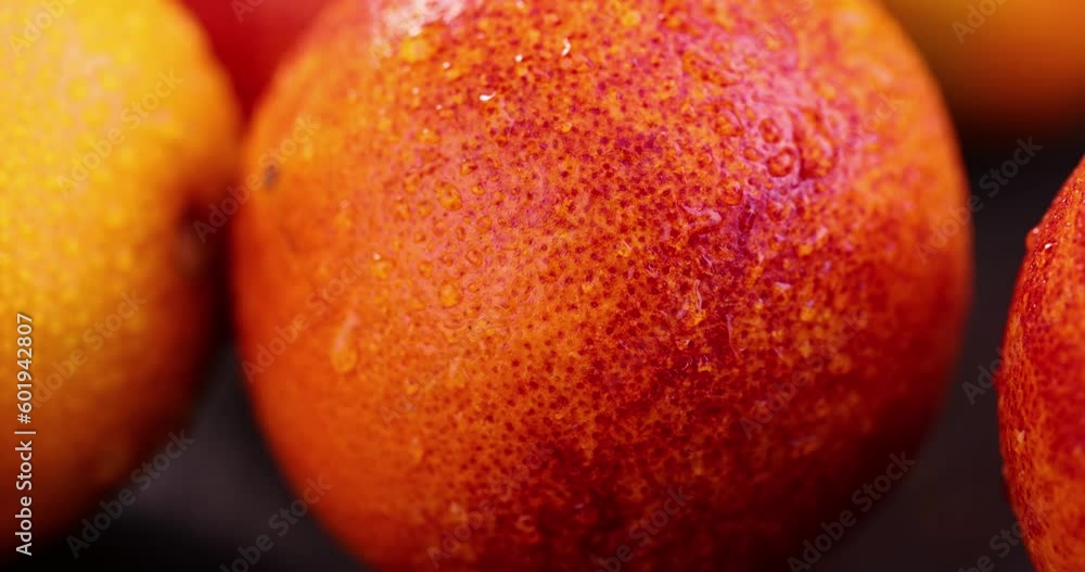 yellow-red orange peel covered with water drops, red ripe orange wet and in drops of pure water, close-up yellow-red orange peel covered with water drops, red ripe orange wet and in drops of pure water, close-up