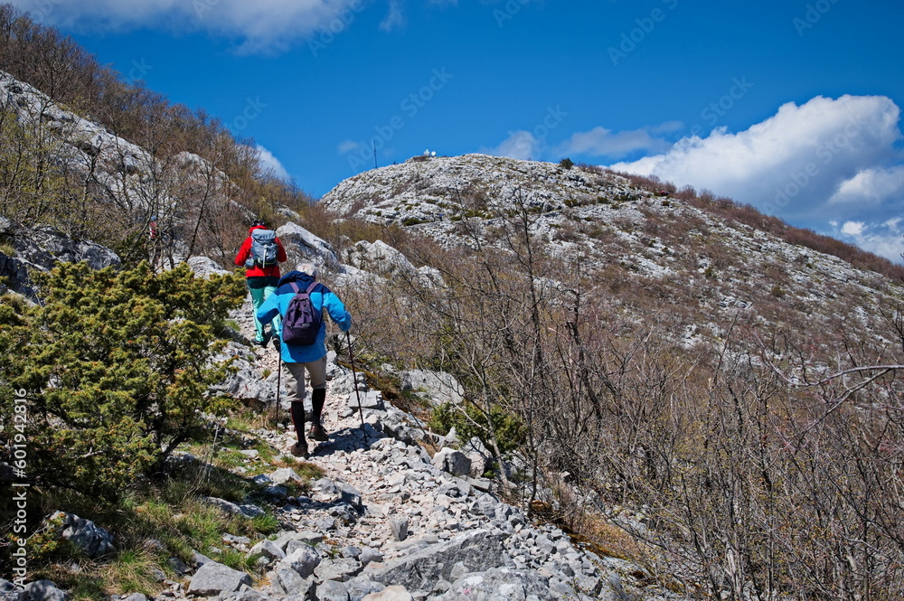 Senior couple hiking in karst landscape in Croatia