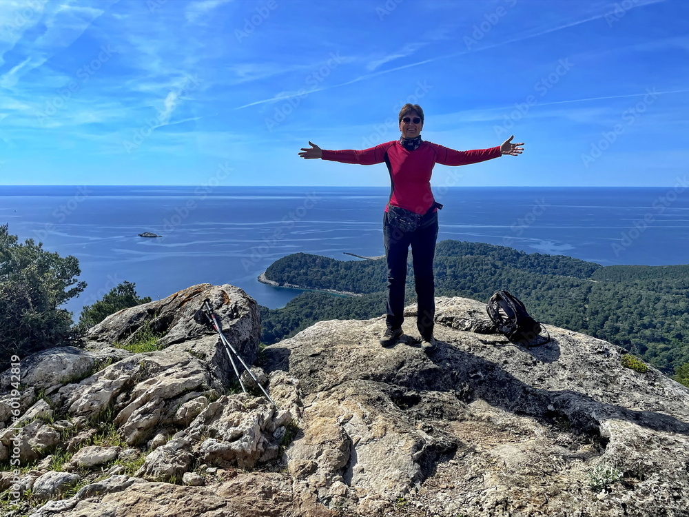 Portrait of senior woman hiking in rocky landscape in Croatia