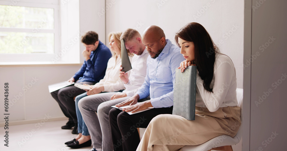 People Bored While Sitting On Chair Waiting For Job Interview People Bored While Sitting On Chair Waiting For Job Interview