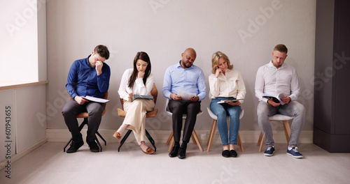 People Bored While Sitting On Chair Waiting For Job Interview