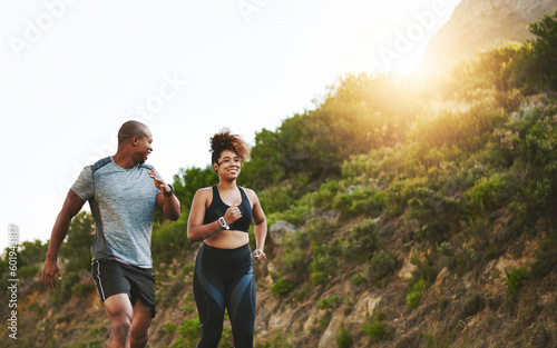 Fitness, nature and couple walking by a mountain training for a race, marathon or competition. Sports, exercise and African athletes or runners doing outdoor running cardio workout together at sunset