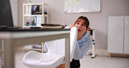 Scared Woman Hiding Behind Chair