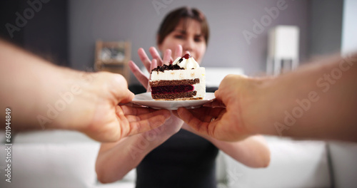 Woman Refusing Slice Of Delicious Cake Offered