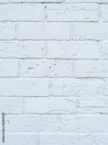 Close up. Brick wall and white surface, clean, rough, uneven surface material. Retro decoration construction and vertical image.