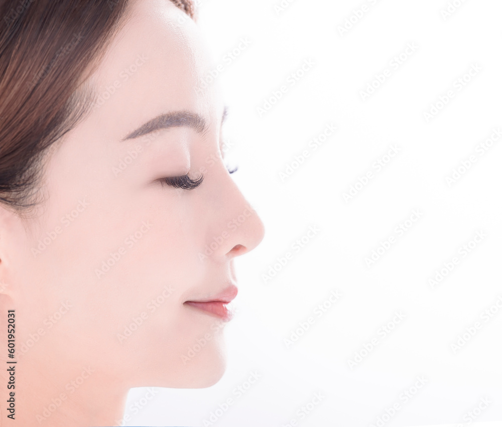 side view of  young asian woman with clean fresh skin on white background