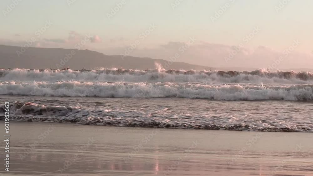 waves crashing on the beach in the afternoon at sunset waves crashing on the beach in the afternoon at sunset