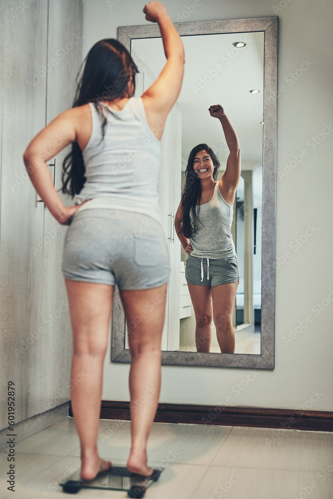 Celebration, weight loss goal and woman with scale and diet success in a home with mirror reflection. Cheering, happy and female person in a house with nutrition progress and a smile from wellness - obrazy, fototapety, plakaty 