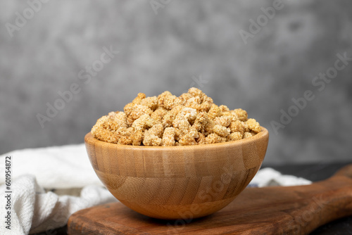 Dried mulberry. Sun-dried organic white dried mulberry in wooden bowl. Superfood, Vegetarian food concept. healthy snacks