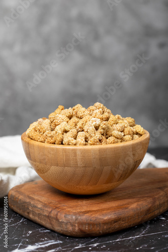 Dried mulberry. Sun-dried organic white dried mulberry in wooden bowl. Superfood, Vegetarian food concept. healthy snacks