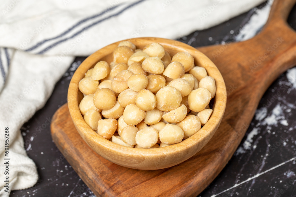 Macadamia Nuts. Macadamia Nuts in wooden bowl. Superfood. Vegetarian food concept. healthy snacks. Close up Macadamia Nuts. Macadamia Nuts in wooden bowl. Superfood. Vegetarian food concept. healthy snacks. Close up