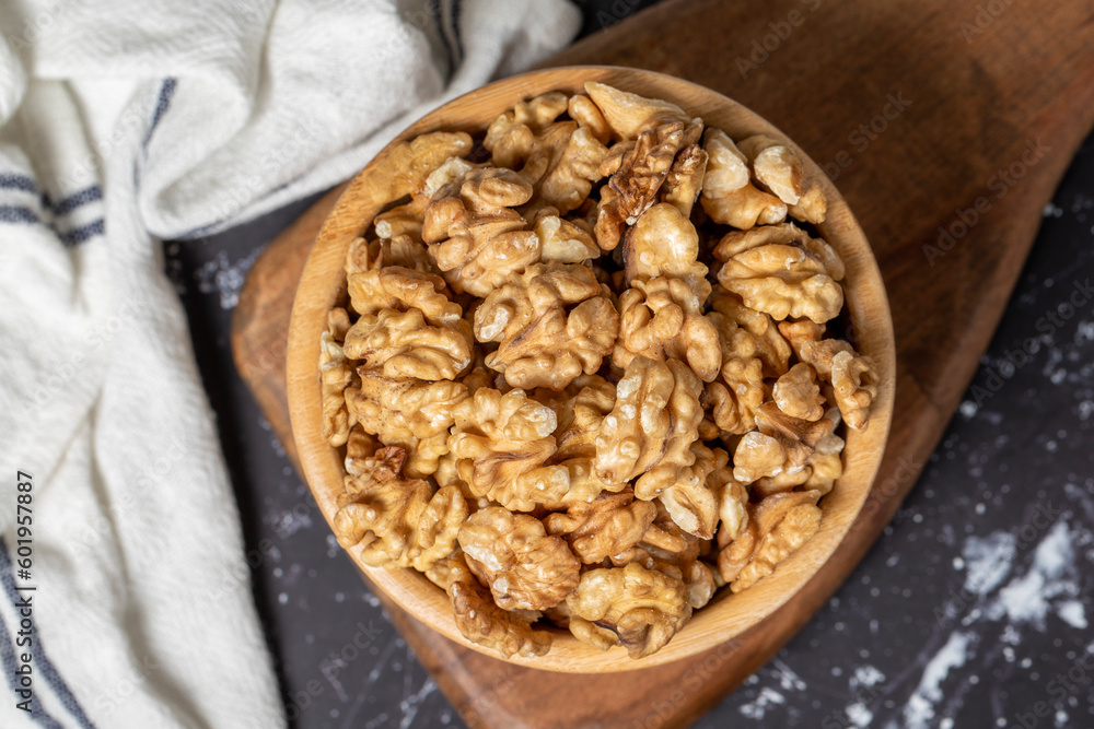 Walnut. Walnut kernel in wooden bowl. Superfood. Vegetarian food concept. Healthy snacks. Top view Walnut. Walnut kernel in wooden bowl. Superfood. Vegetarian food concept. Healthy snacks. Top view