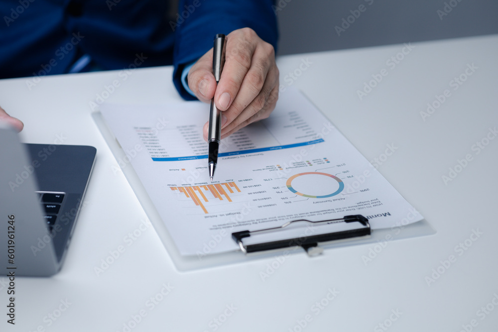Businessman sits in a private office at his company and is reviewing company financial documents, senior management checking financial information for accuracy. Financial management. Businessman sits in a private office at his company and is reviewing company financial documents, senior management checking financial information for accuracy. Financial management.