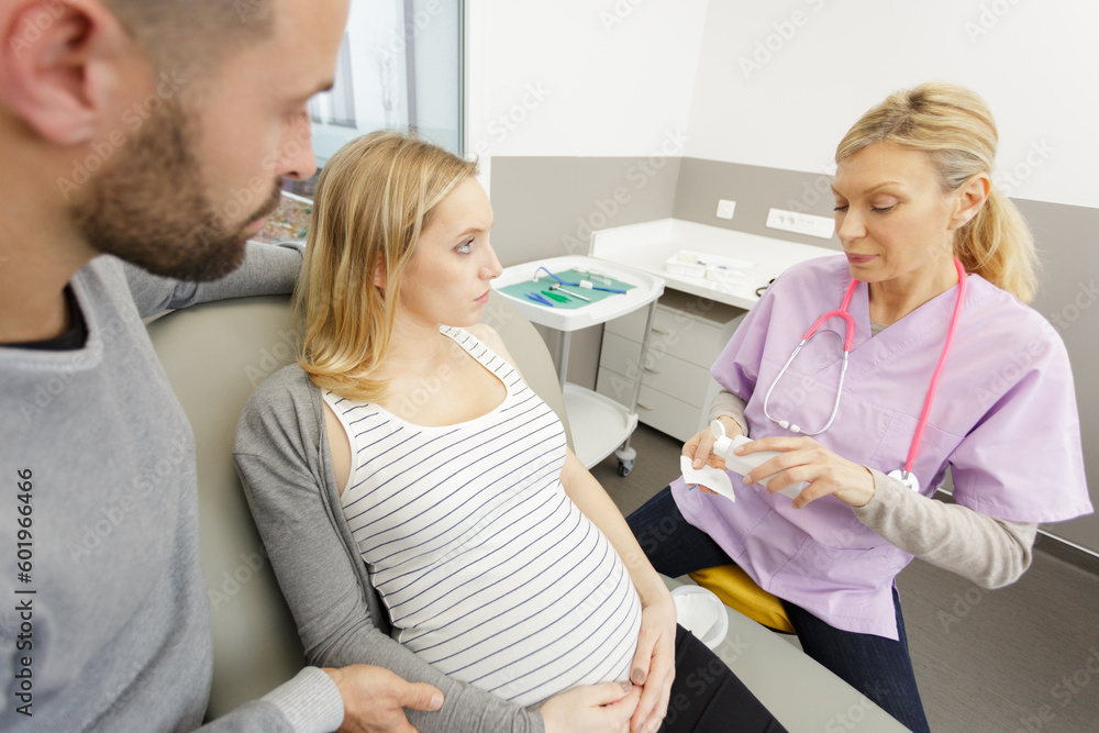 Fototapeta premium young pregnant couple doing ultrasound scan