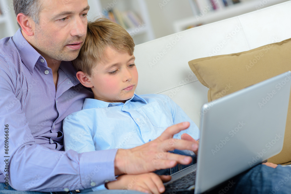 Adult and child using laptop Adult and child using laptop