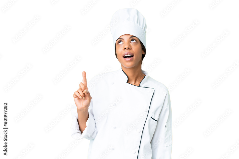 Young African American chef over isolated chroma key background pointing up and surprised Young African American chef over isolated chroma key background pointing up and surprised