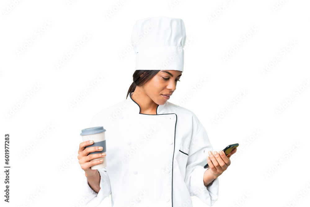 Young African American chef over isolated chroma key background holding coffee to take away and a mobile Young African American chef over isolated chroma key background holding coffee to take away and a mobile