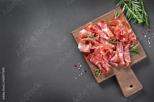 Cured Meat Platter, Coppa with Spices, Italian Antipasto, Appetizer over Dark Background