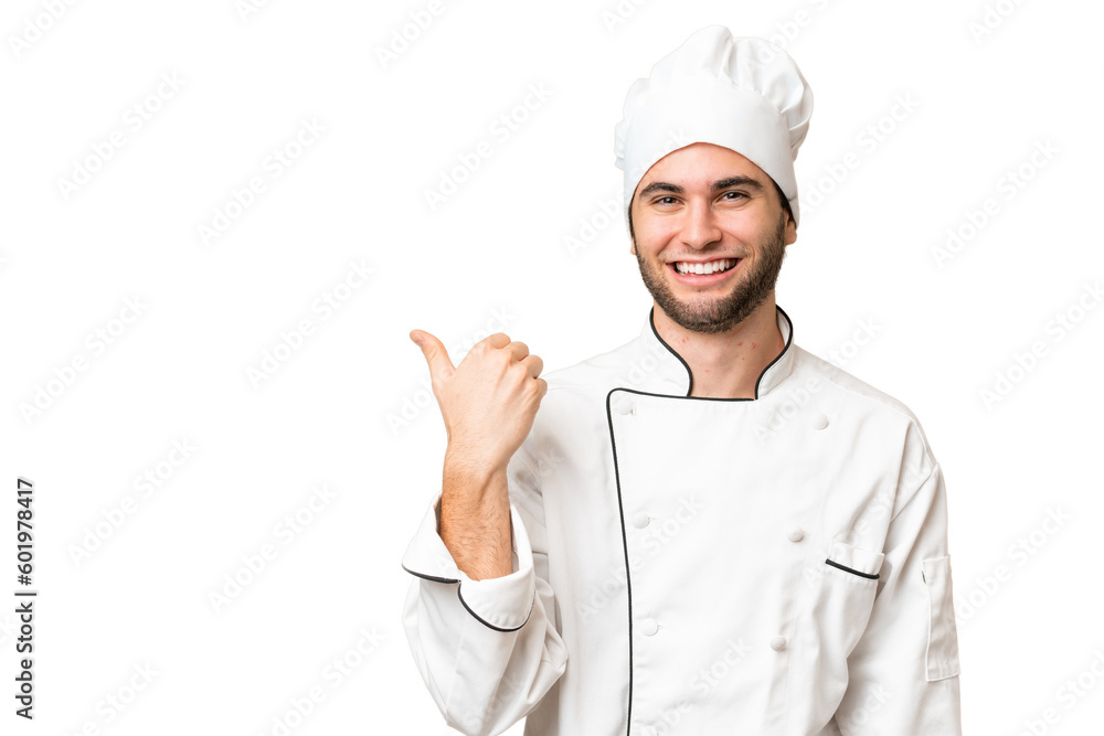 Young handsome chef man over isolated background pointing to the side to present a product Young handsome chef man over isolated background pointing to the side to present a product