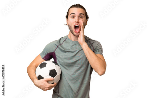 Young handsome football player man over isolated background with surprise and shocked facial expression