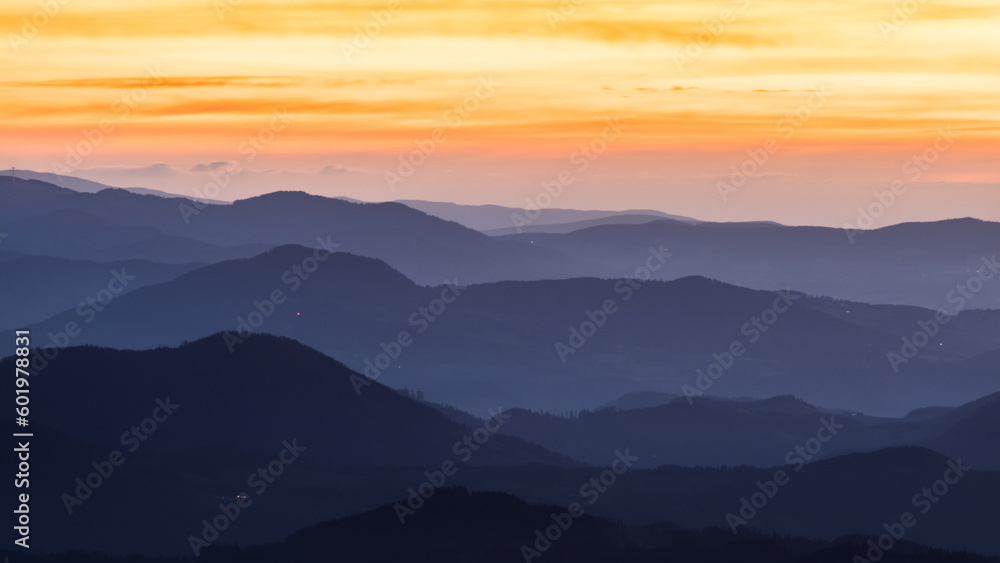 Mountain layers with a dramatic sky before sunrise