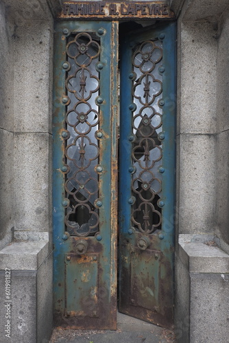 Rust deteriorations. Really old and decrepit door from a century-old cemetery (Père Lachaise, France)