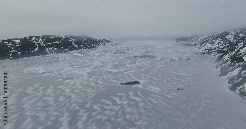 Ice in Highlands of Iceland. Drone Shot of Frozen Glacial Lake and Icebergs Under Glacier on Cold Winter Day Ice in Highlands of Iceland. Drone Shot of Frozen Glacial Lake and Icebergs Under Glacier on Cold Winter Day