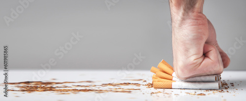Male hand breaking a cigarettes. Quitting smoking