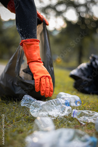 Man picking up plastic waste to clean up at a park