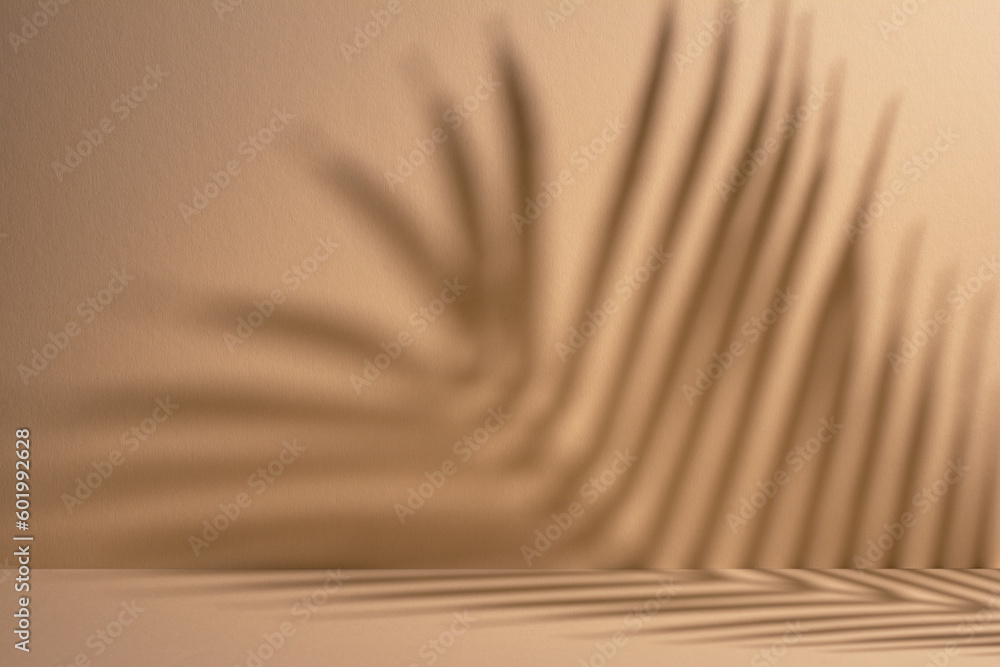 Abstract background of shadows palm leaves on a sand color wall - obrazy, fototapety, plakaty 