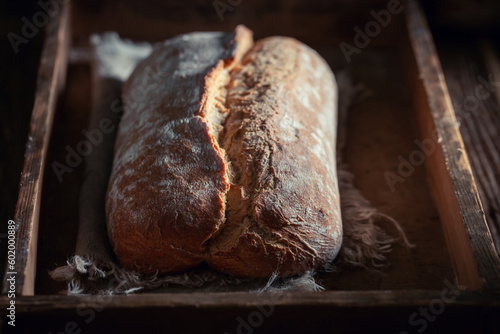 Homemade and tasty loaf of bread on rutic table. photo