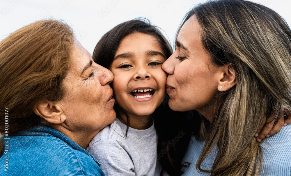 Happy Hispanic family enjoying time together - Child having fun with her mother and grandmother Happy Hispanic family enjoying time together - Child having fun with her mother and grandmother
