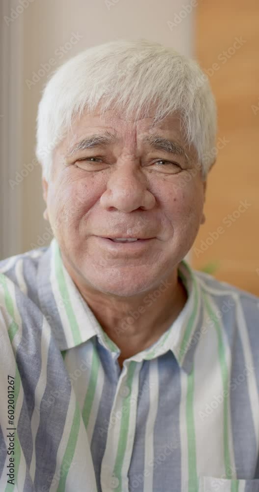 Vertical video of portrait of happy senior caucasian man having video call in slow motion Vertical video of portrait of happy senior caucasian man having video call in slow motion