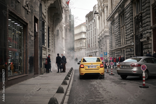 A mans working with a smoke machine outside photo