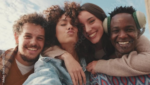 Happy smiling friends taking selfie on mobile phone